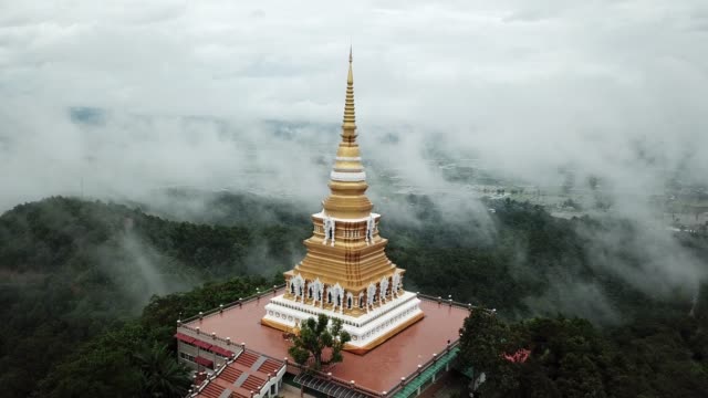 Aerial-view,-Wat-Mon-Pra-Jao-Lai-with-fog-on-the-mountain-in-Chiang-Rai,-Thailand.