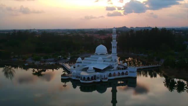 Aerial-4k-footage-of-floating-mosque-during-sunset-in-a-tropical-country.