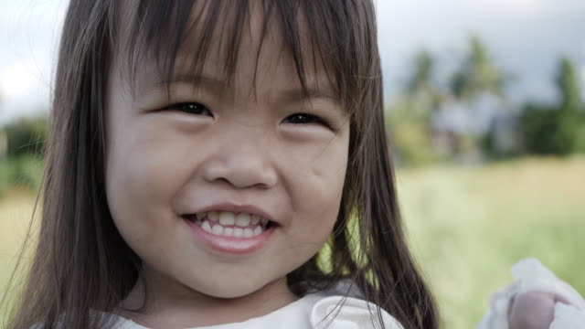 Slow-motion,-Close-up-adorable-little-girl-smiling-and-shy
