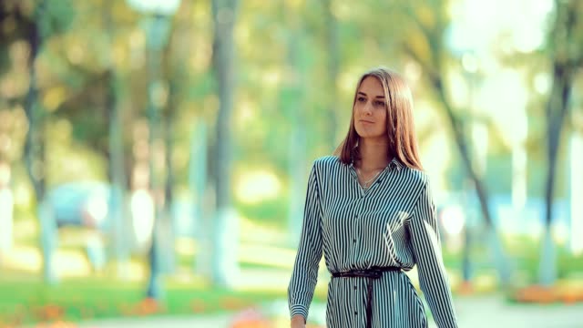 Young-beautiful-woman-is-walking-in-the-park