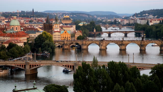 Scenic-summer-sunset-aerial-view-of-the-Prague-Old-Town-pier-architecture-and-Charles-Bridge-over-Vltava-river-in-Prague,-Czech-Republic