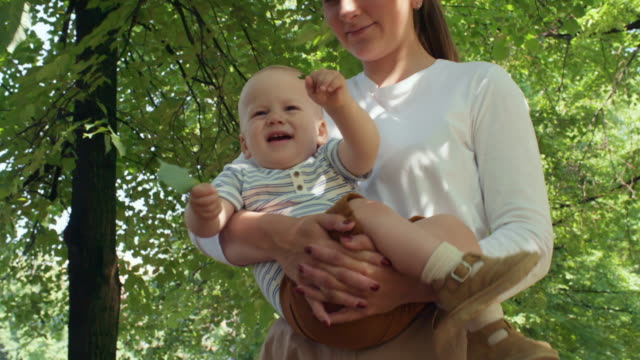 Madre-con-bebé-curioso-caminar-en-el-Parque
