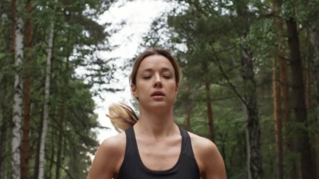 Determined-Young-Woman-Jogging-in-Forest