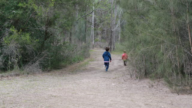 Two-Boys-Running-in-Forest