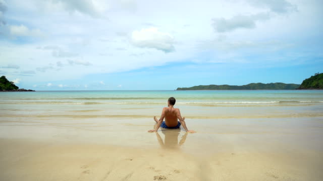 Man-sitting-on-the-beach