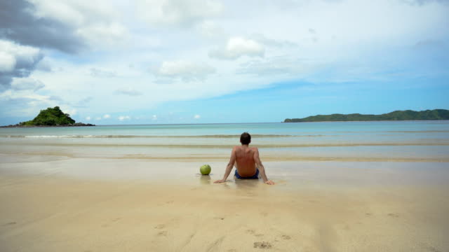 Man-sitting-on-the-beach