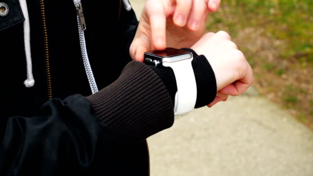 Woman-using-smartwatch-in-the-park-4k