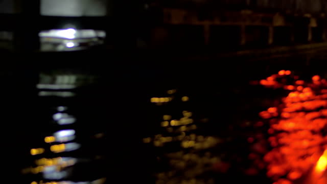 Cerrar-vista-de-onda-de-río-sobre-el-barco-por-la-noche,-Ámsterdam,-Países-Bajos