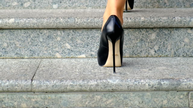 Woman-on-high-heels-walking-up-the-stairs,-close-up