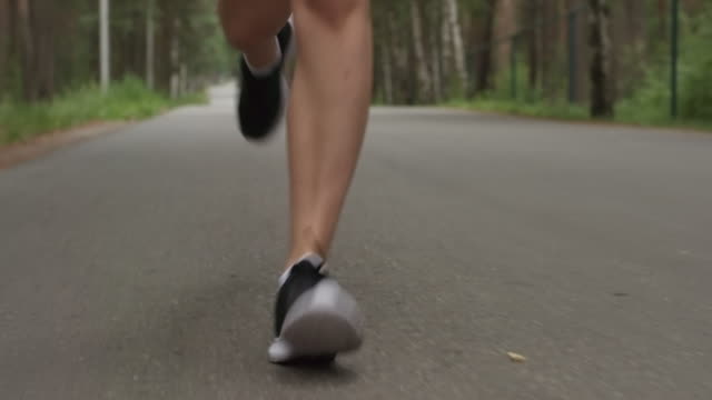 Fit-Sportswoman-Jogging-along-Forest-Road