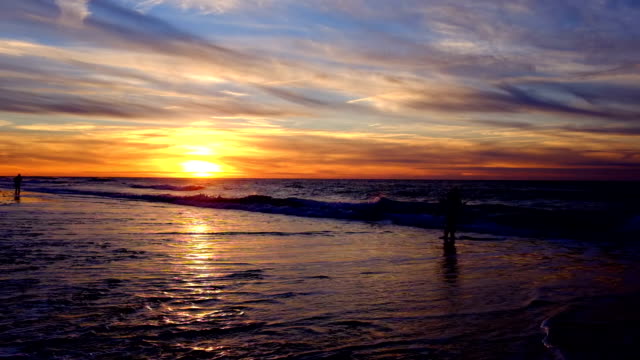 Fishermen-at-the-beach-fishing-at-sunset