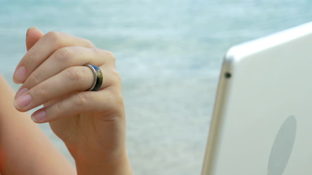 Woman-using-smart-ring-to-control-computer
