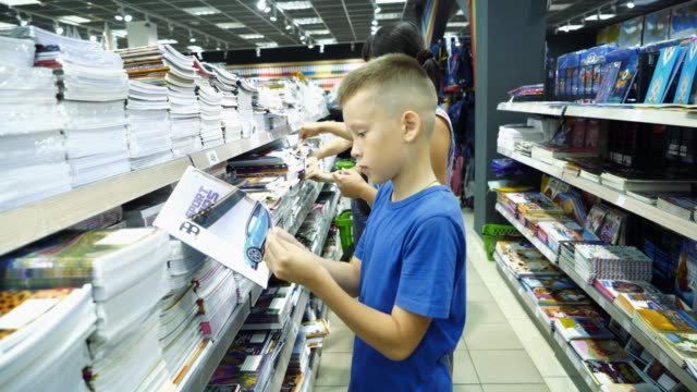 Little-boy-is-buying-stationery-for-school.