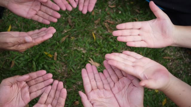 Hand-give-a-red-heart-to-many-hands-of-people