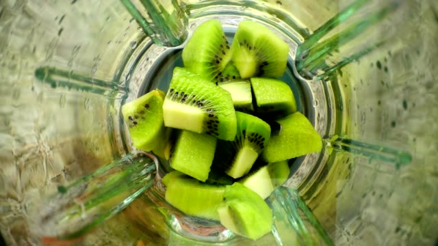 Crushing-of-a-kiwi-in-the-blender.-Slow-motion.	Preparation-of-smoothie-in-the-blender.