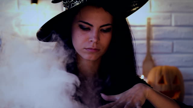 Beautiful-woman-in-witch-costume-making-magic-potion,-preparing-for-Halloween
