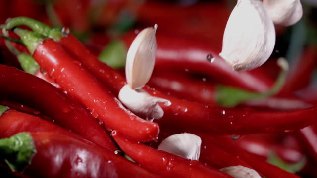Falling-of-garlic-into-the-red-hot-pepper.-Slow-motion-240-fps