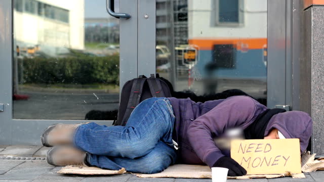 Homeless-beggar-man-sleeping-on-the-street