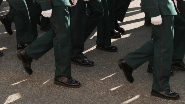 Soldier-of-military-army-walking-in-boots-closeup-in-the-parade-of-city-square.