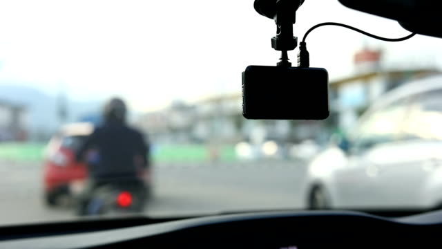 video-camera-recorder-in-car-driving-on-traffic-road,-slow-motion-shot