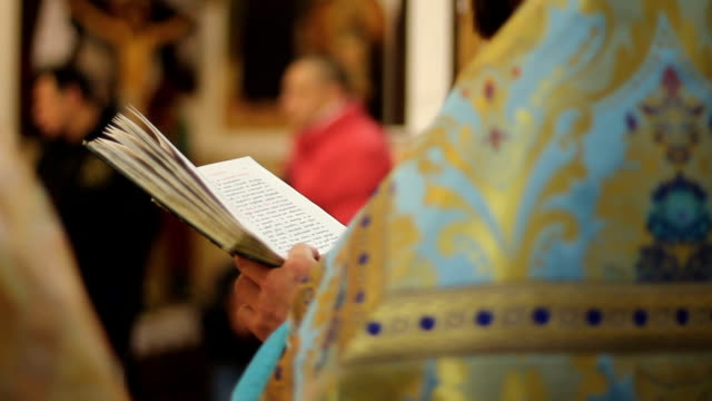 Orthodox-Church-clergyman-reading-psalm-book,-conducting-festive-service,-prayer