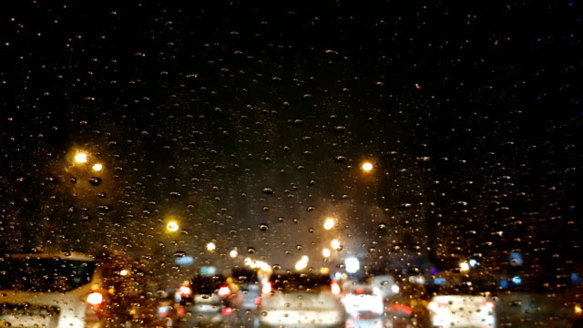 Traffic-jam-in-the-rain,-driver-pov,-cars-driving-slowly,-evening-in-city
