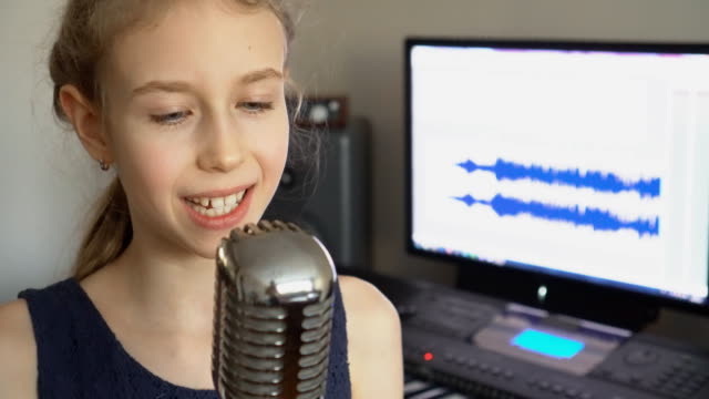 Little-girl-singing-a-song-in-home-recording-studio.