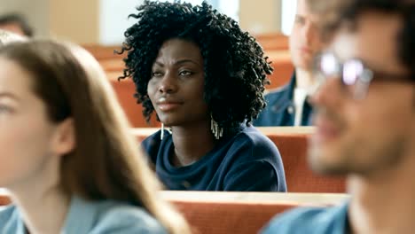 In-the-Classroom-Multi-Ethnic-Students-Listening-to-a-Lecturer-and-Writing-in-Notebooks.-Smart-Young-People-Study-at-the-University.