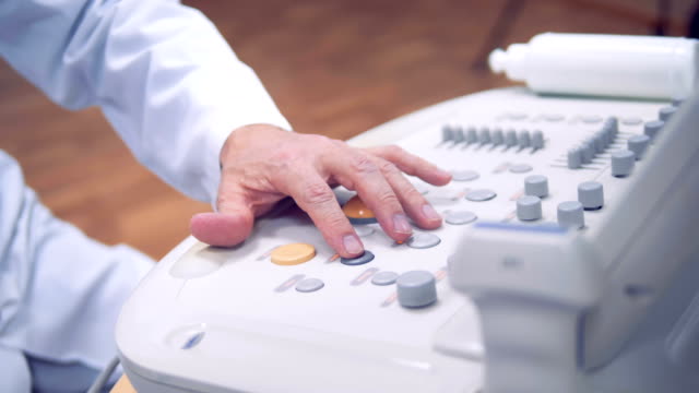 The-doctor's-hand-controls-the-examination-process-of-the-patient.