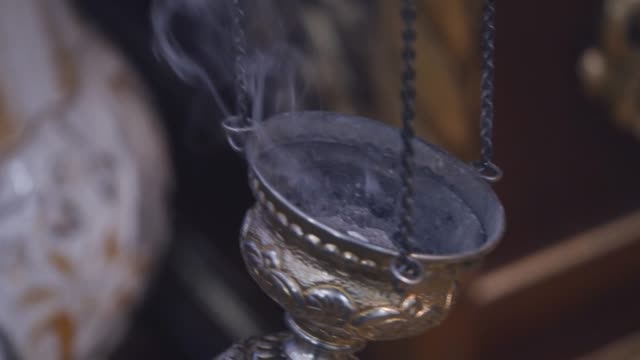 Smoking-device-in-the-middle-of-the-ritual.-Close-up-slow-motion-footage-of-a-smoking-device-in-the-middle-of-the-ritual-in-the-middle-of-the-church
