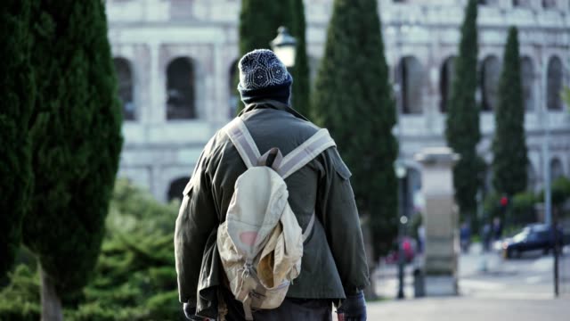 homeless-man-walking-towards-the-colosseum--Rome,-Italy