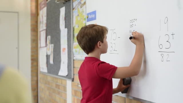 School-boy-solving-math-problem