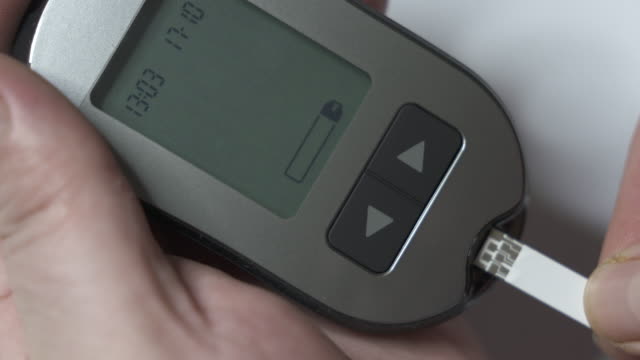 Patient-with-diabetes-using-a-blood-glucose-meter-to-test-blood-glucose