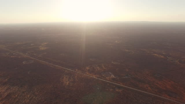 Aerial-drone-images-of-the-road-in-the-Brazilian-semi-arid-region,-plain-landscape-and-sunlight