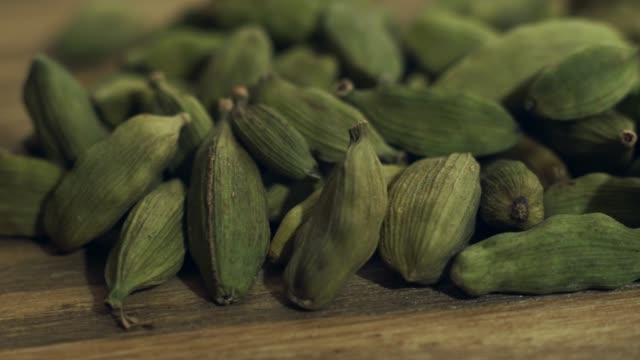 green-cardamom-on-a-wooden-table.-4k