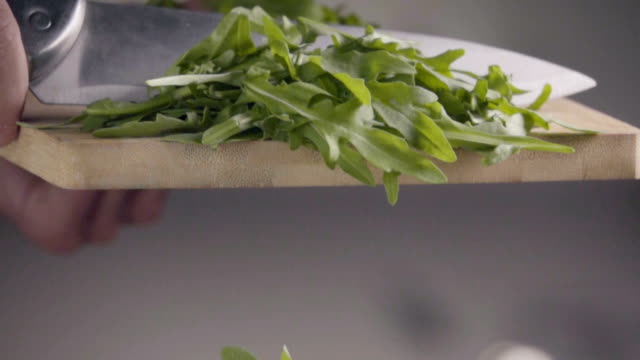 Falling-of-arugula-into-the-frying-pan.-Slow-motion-480-fps
