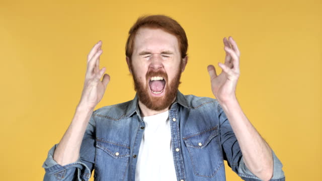 Screaming-Angry-Redhead-Man-Isolated-on-Yellow-Background