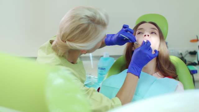 Doctor-working-with-patient-in-modern-dental-clinic.-Female-dentist