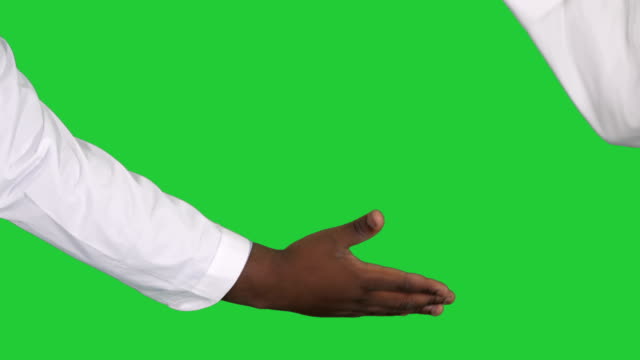 Two-handsome-doctors-are-giving-high-five-and-smiling,-standing-in-a-modern-operating-room-on-a-Green-Screen,-Chroma-Key