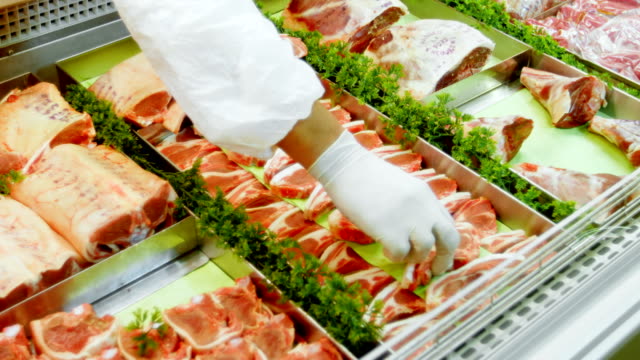 Butcher-arranging-meat-in-refrigerator-4k