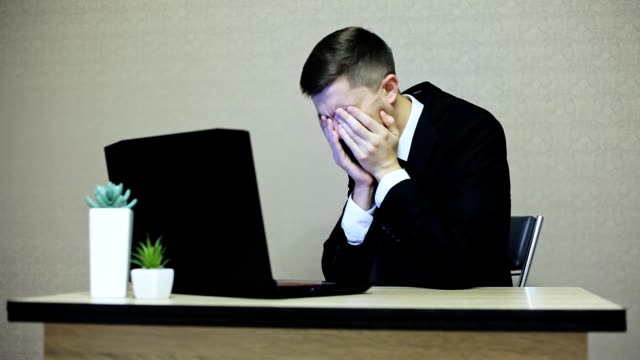 Businessman-crying-in-the-workplace.-He's-upset,-bad-luck,-then-calms-down