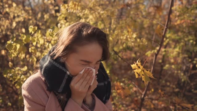 Sick-girl-sneezing-outdoor.