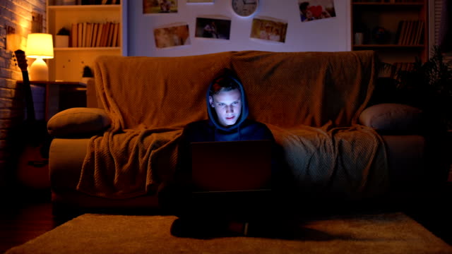 Teenager-surfing-in-internet-visiting-gambling-sites-winning-money,-young-hacker
