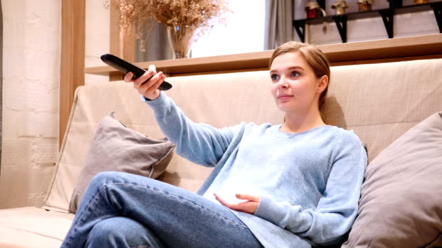 Woman-Watching-TV,-Changing-Channels-with-Remote-Control