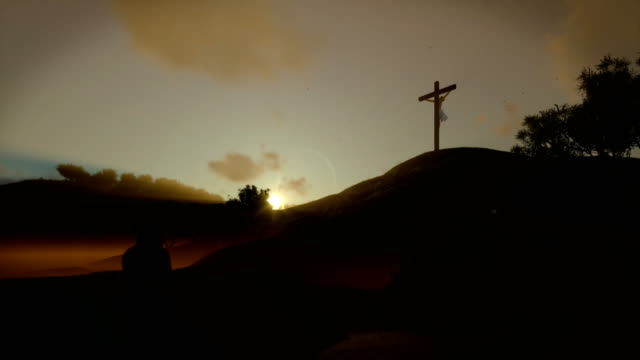 Christian-woman-praying-at-Jesus-cross-at-sunset,-panning,-4K