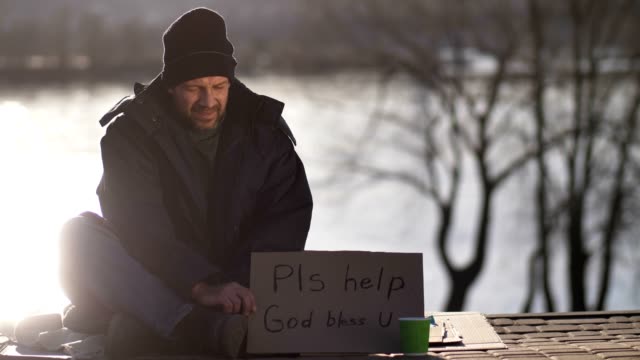 Male-begging-for-money-with-cardboard-sign