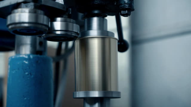 Close-up-of-rolling-cans-in-production