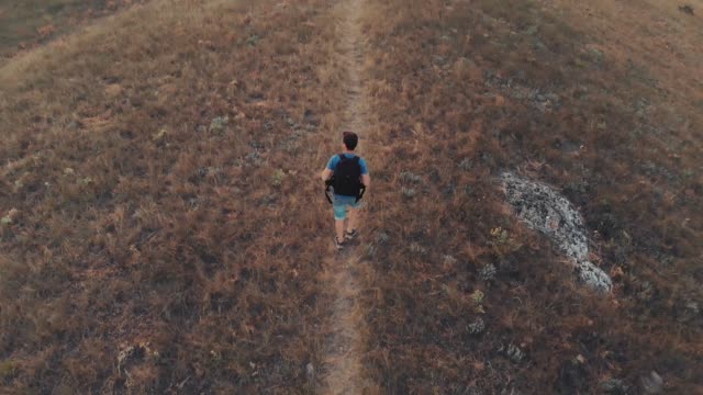 Man-with-backpack-hiking-aerial-view