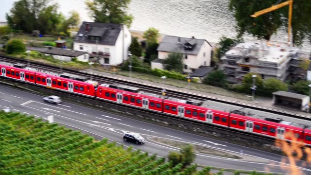 Footage,-a-red-passenger-train-goes-through-the-city.