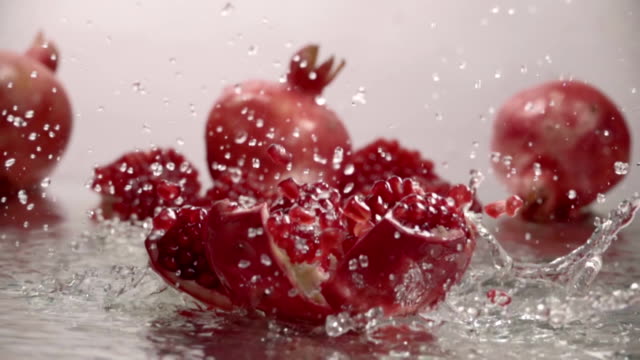 Falling-splitted-pomegranate-into-the-water-.-Slow-motion